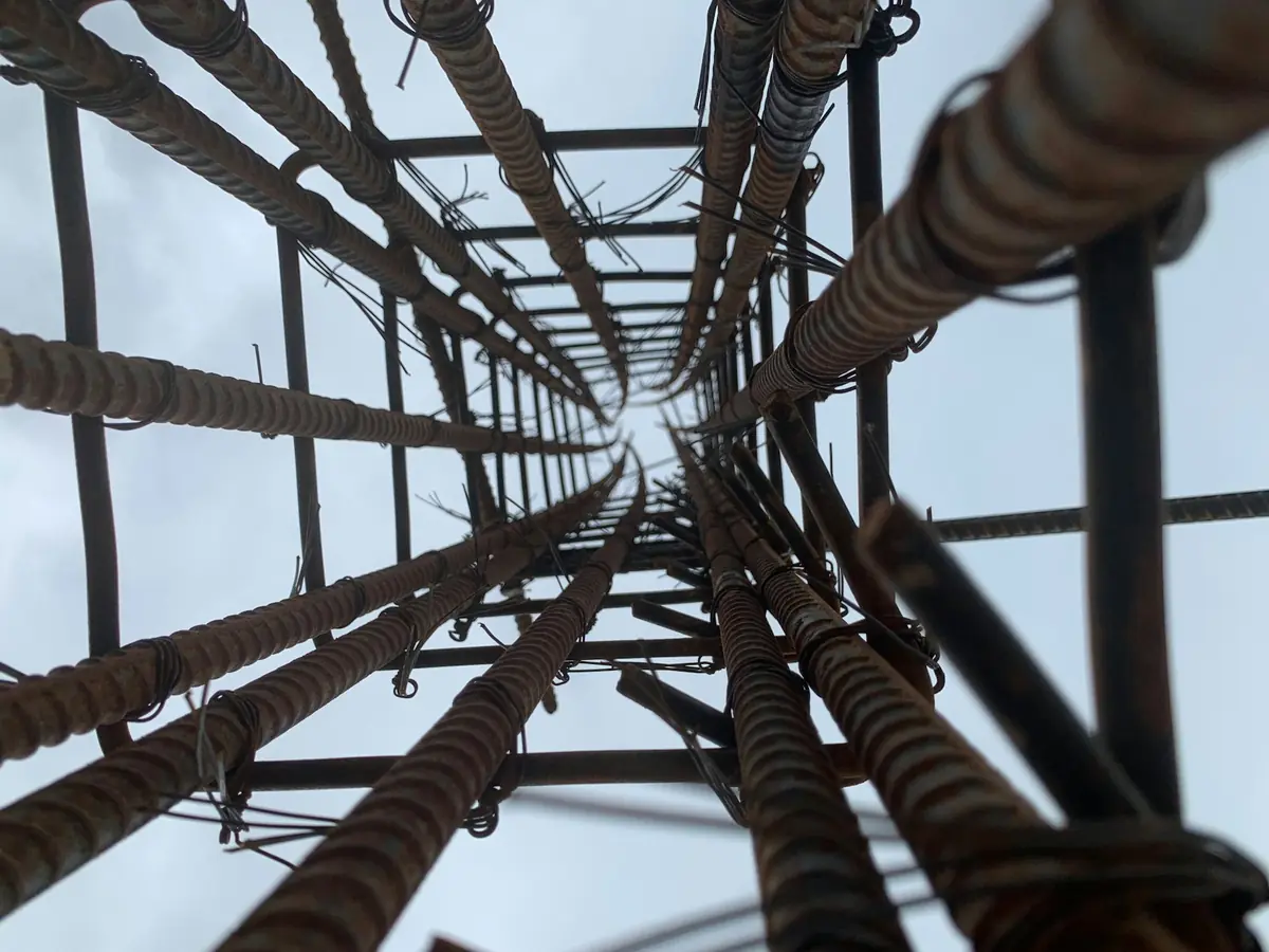 Cage d’armatures en acier vue de l’intérieur, vers le ciel